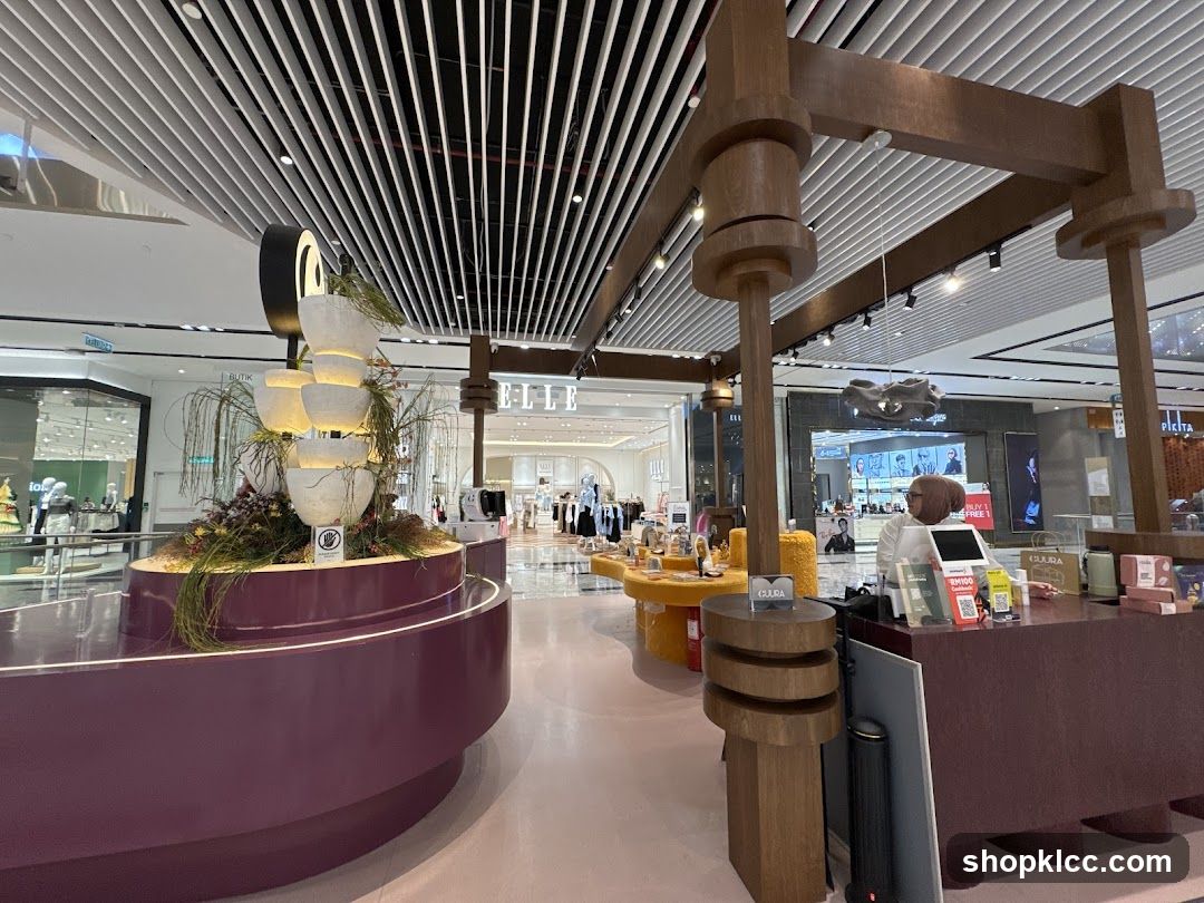 Interior of a shopping mall with a decorative display and a retail counter