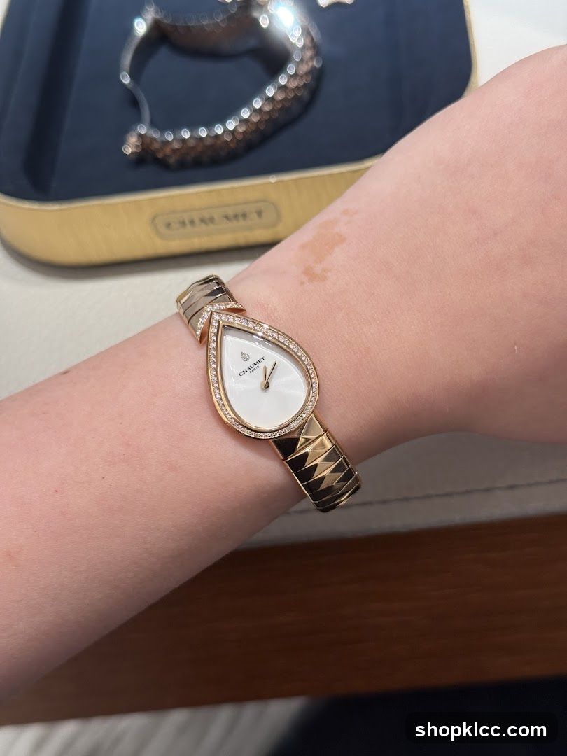 Woman wearing a diamond-encrusted pear-shaped watch