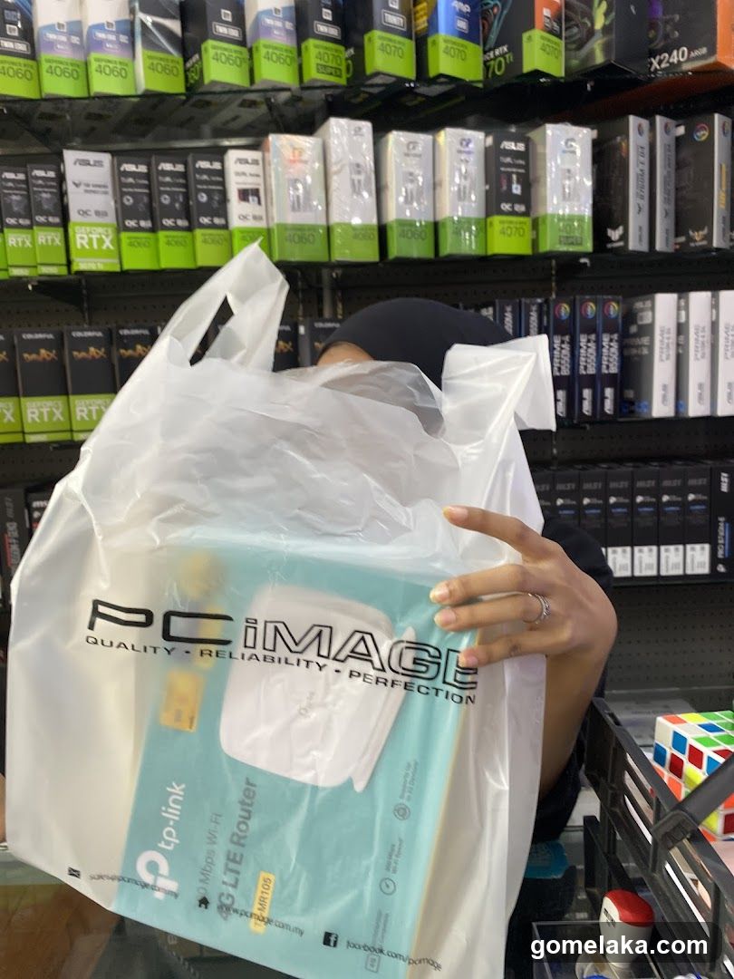 Customer holding shopping bag in electronics store