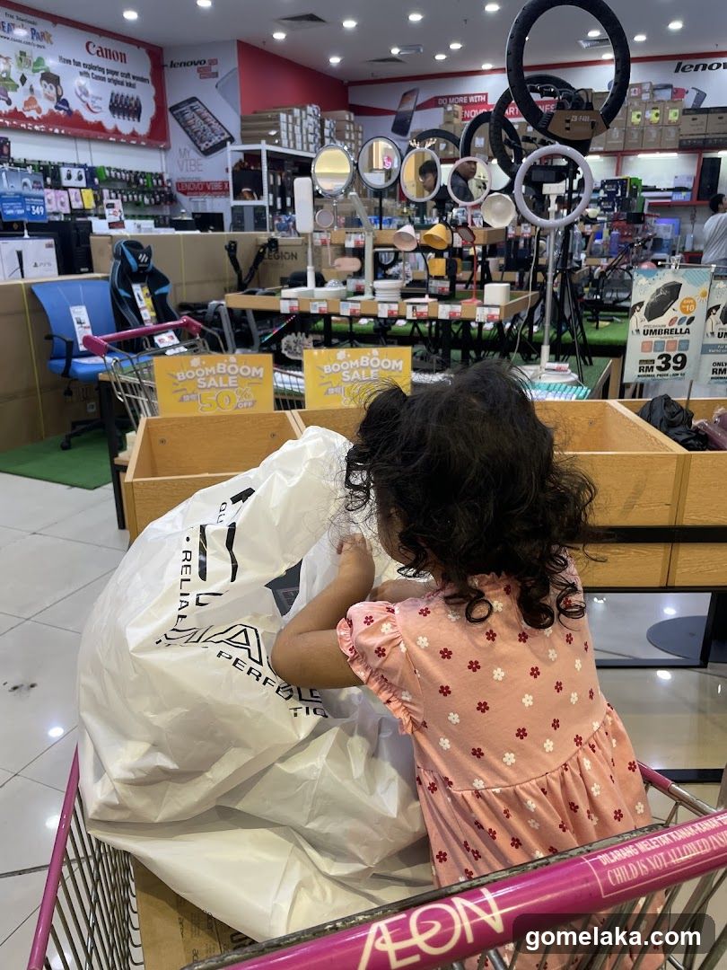 Child in shopping cart at AEON store
