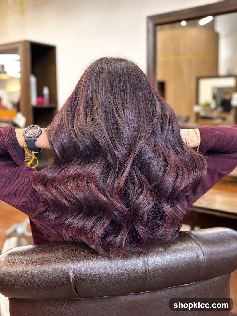 Woman with long, wavy, dark auburn hair