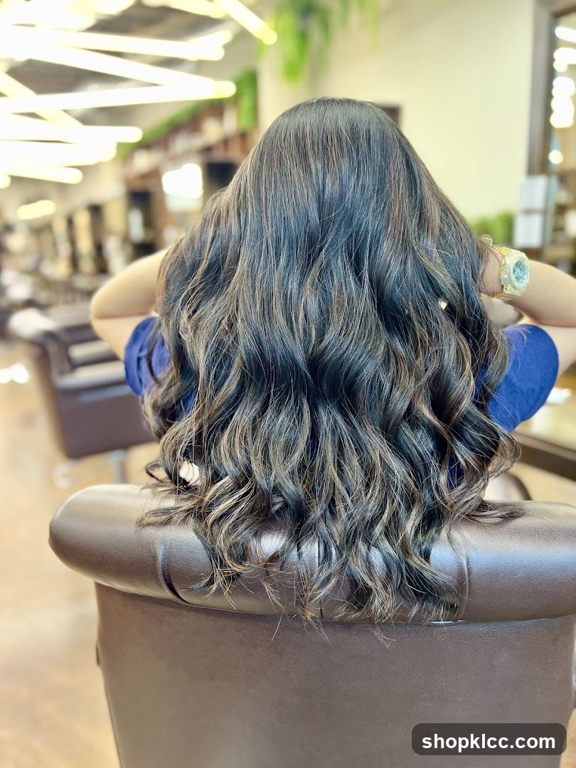 Woman with long, wavy, highlighted hair