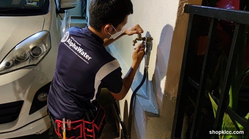 Plumber fixing water tap