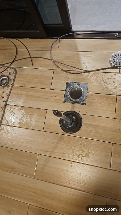 Floor with Plumbing Tools and Drain Cover