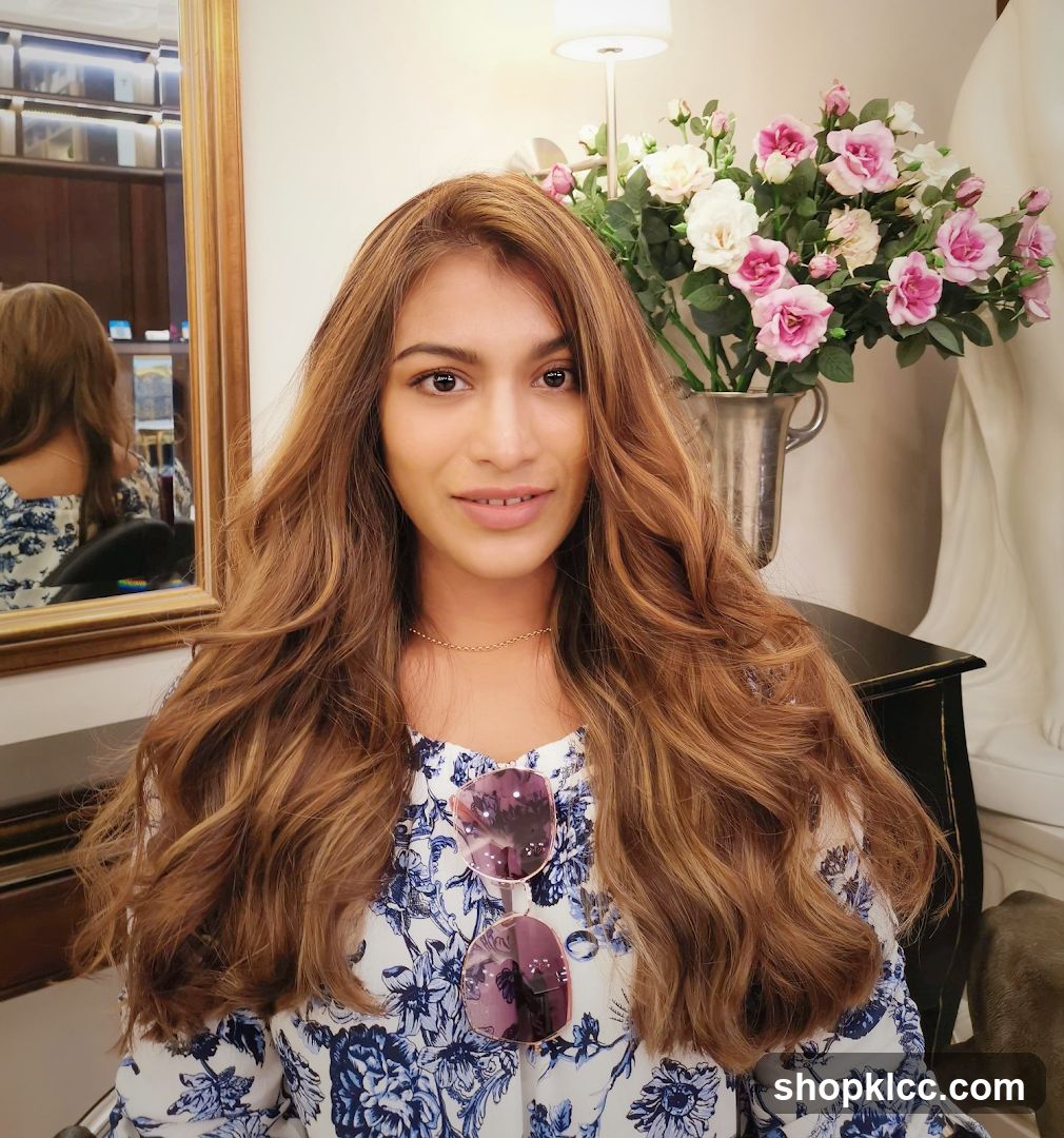 Woman with long wavy hair in a salon or boutique setting