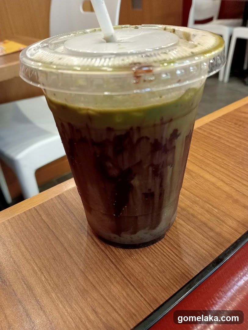 Iced beverage in plastic cup with straw