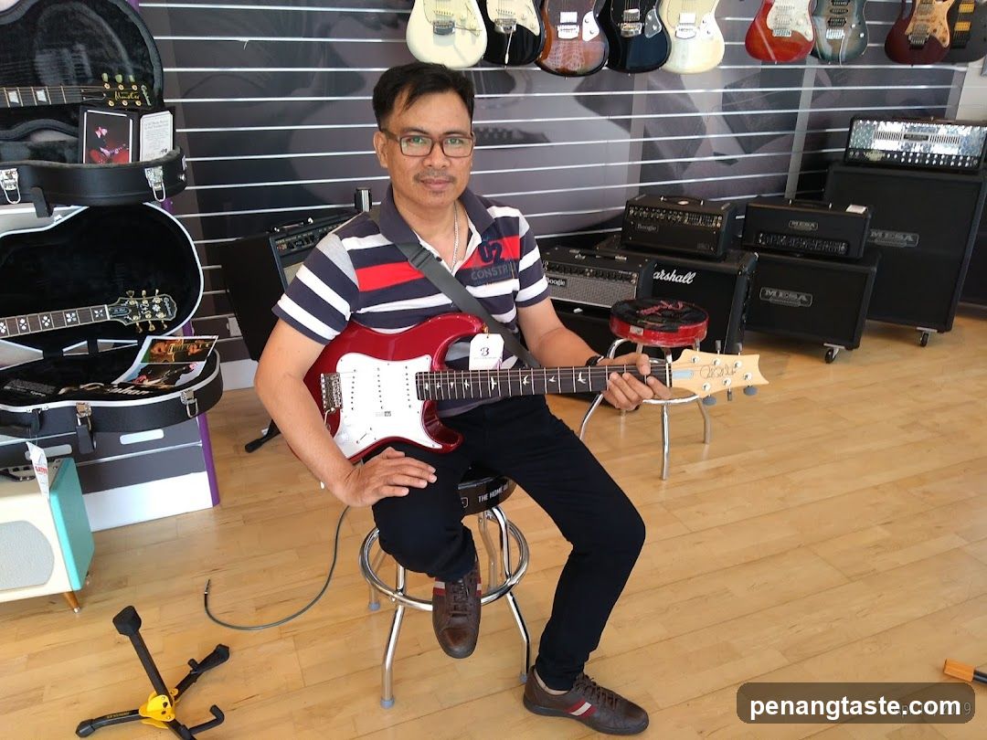 Man playing a guitar in a music store