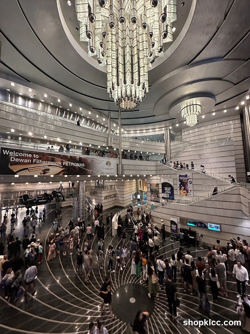 Interior of a large, modern building with a grand chandelier