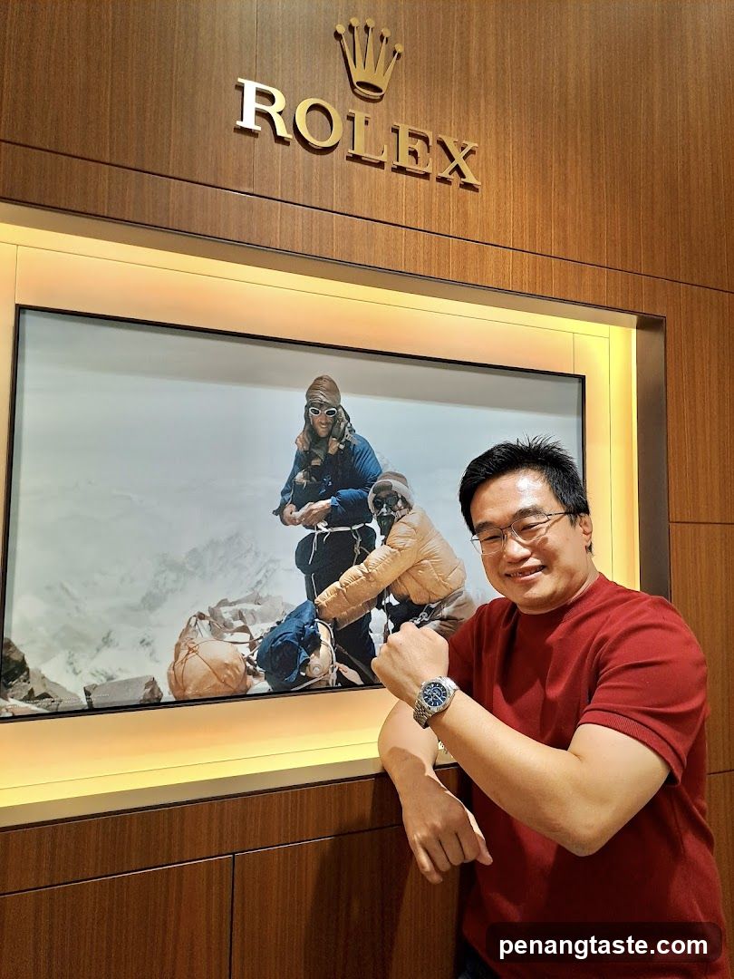 Man Posing with Rolex Watch in Front of Display