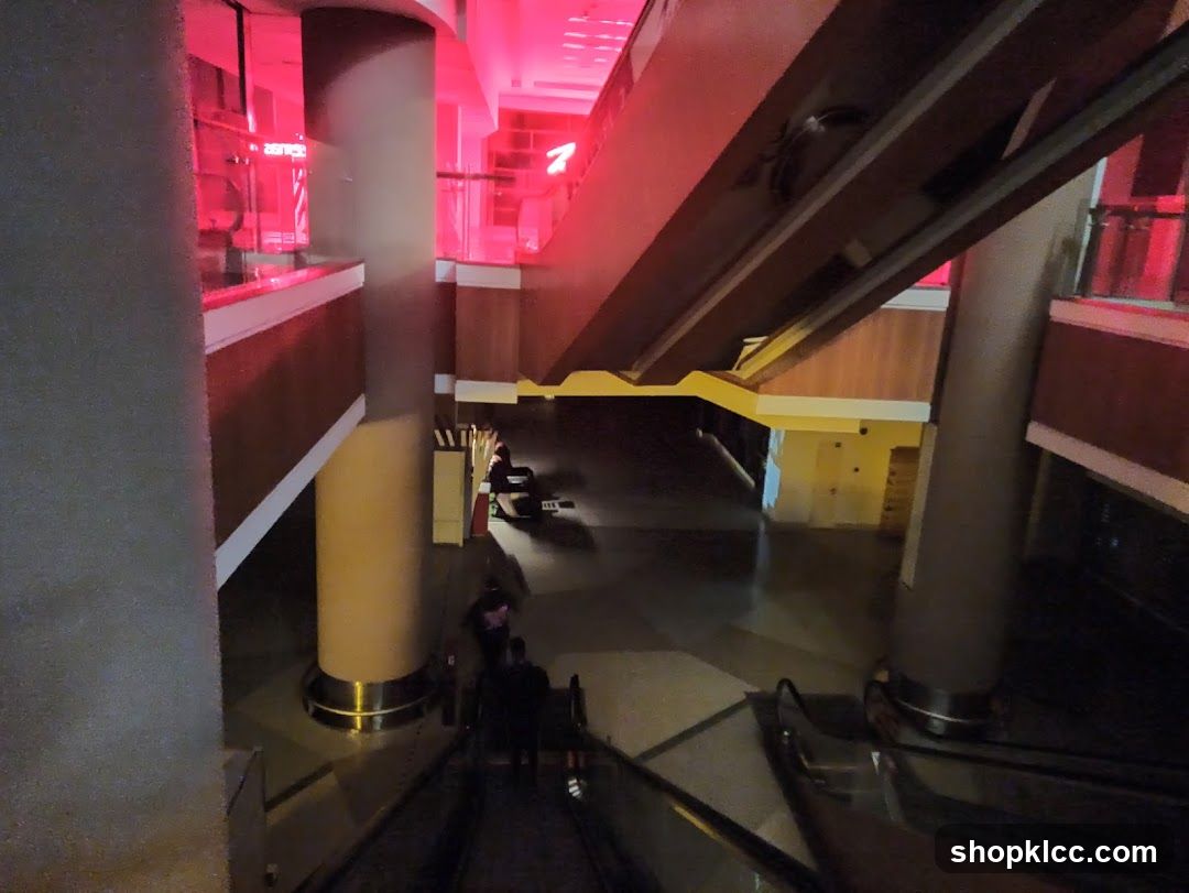 Interior of a building with escalators and red lighting