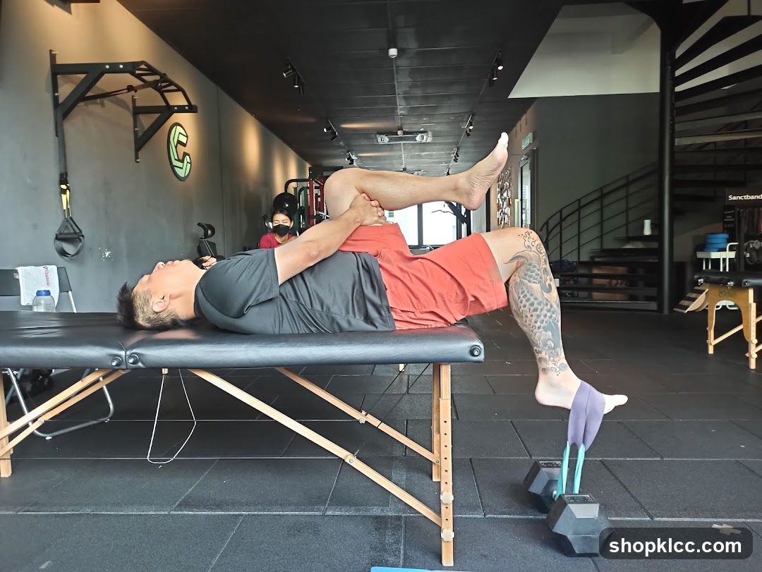 Man stretching on a table in a gym