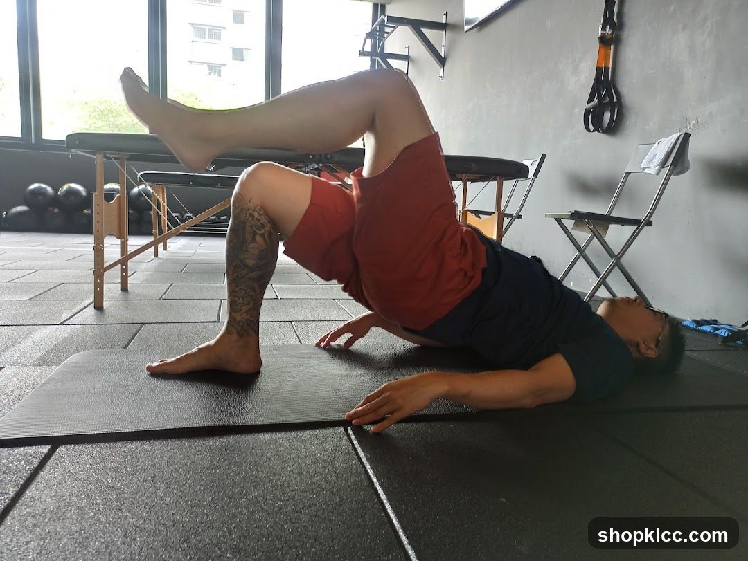 Man performing a glute bridge exercise