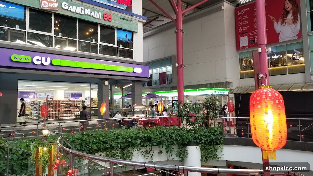Indoor shopping mall with various shops and decorations
