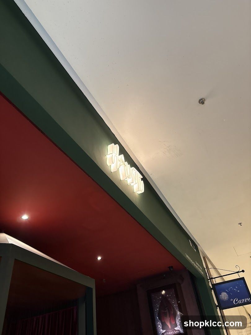 Storefront with illuminated signage and hanging sign