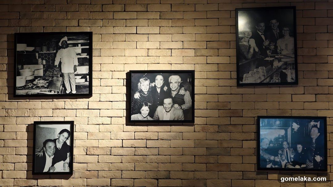 Framed photographs on a brick wall