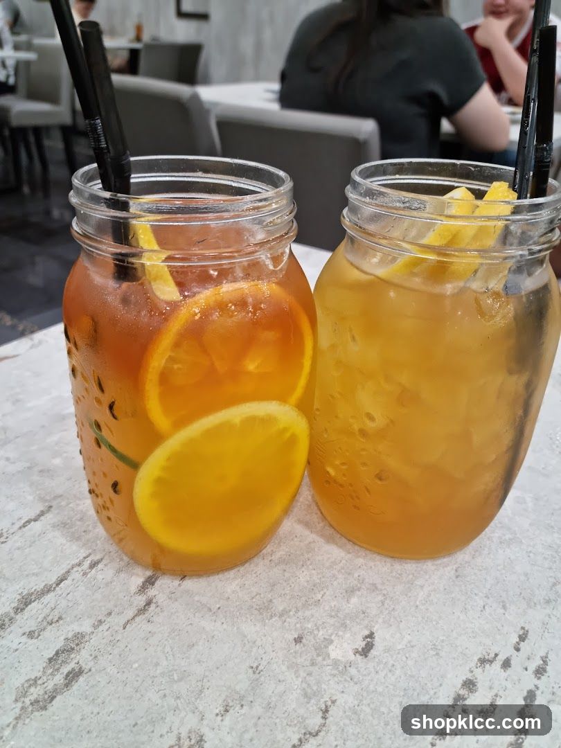 Two iced drinks with fruit