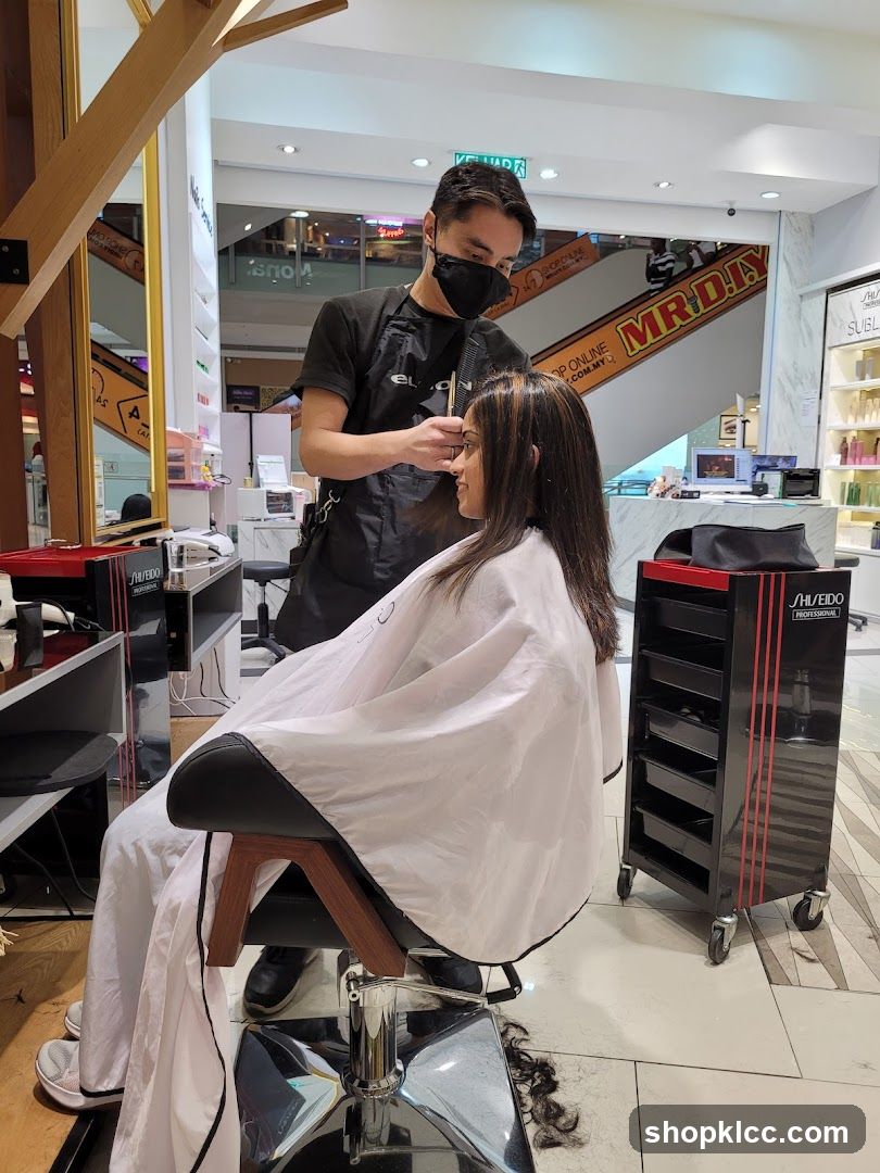 Hairdresser cutting client's hair
