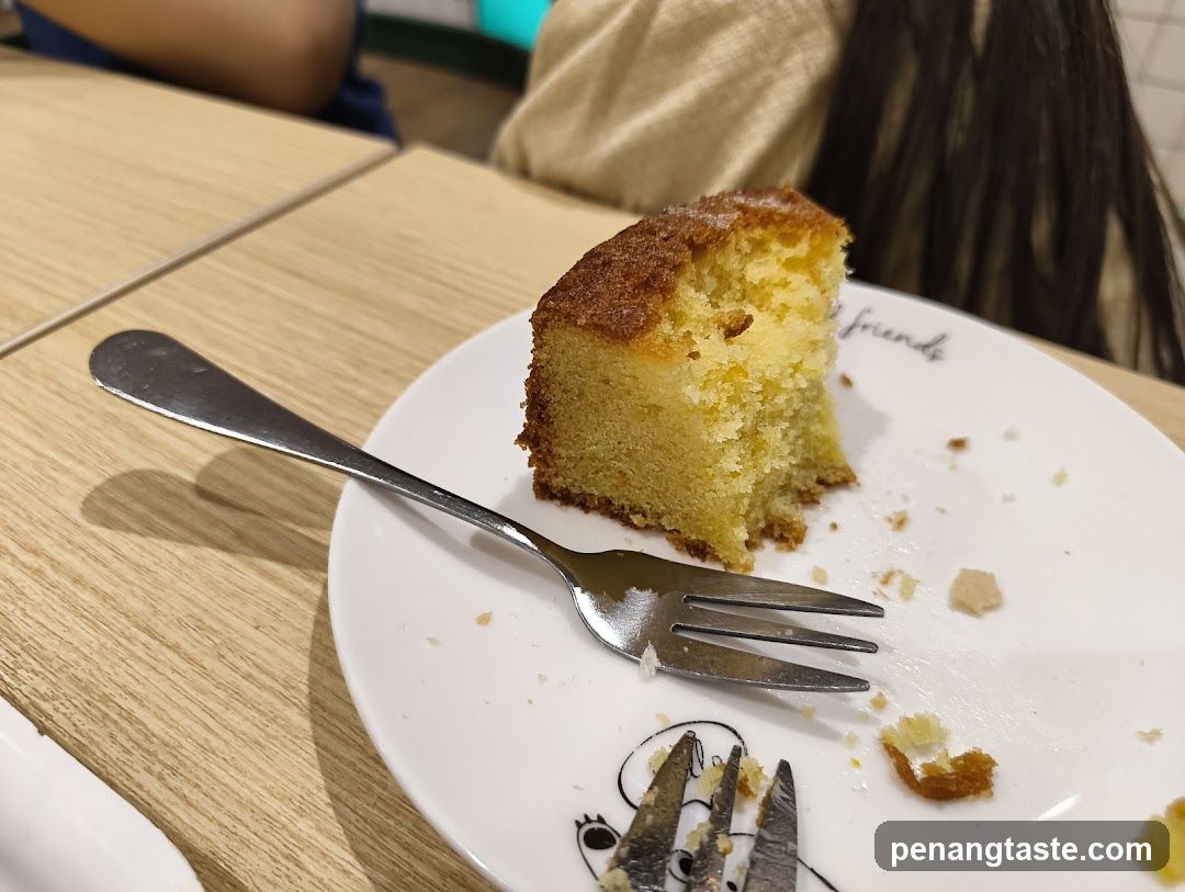 Slice of cake on a plate with a fork