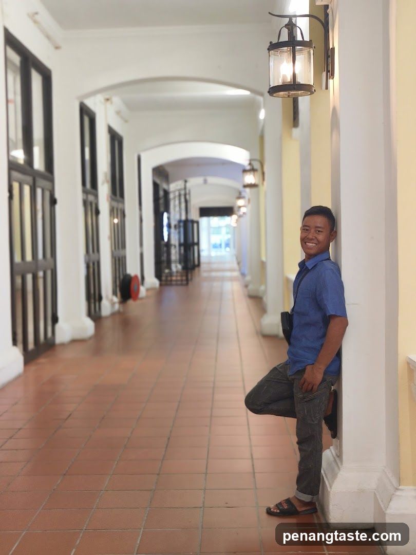 Man leaning against a pillar in a covered walkway
