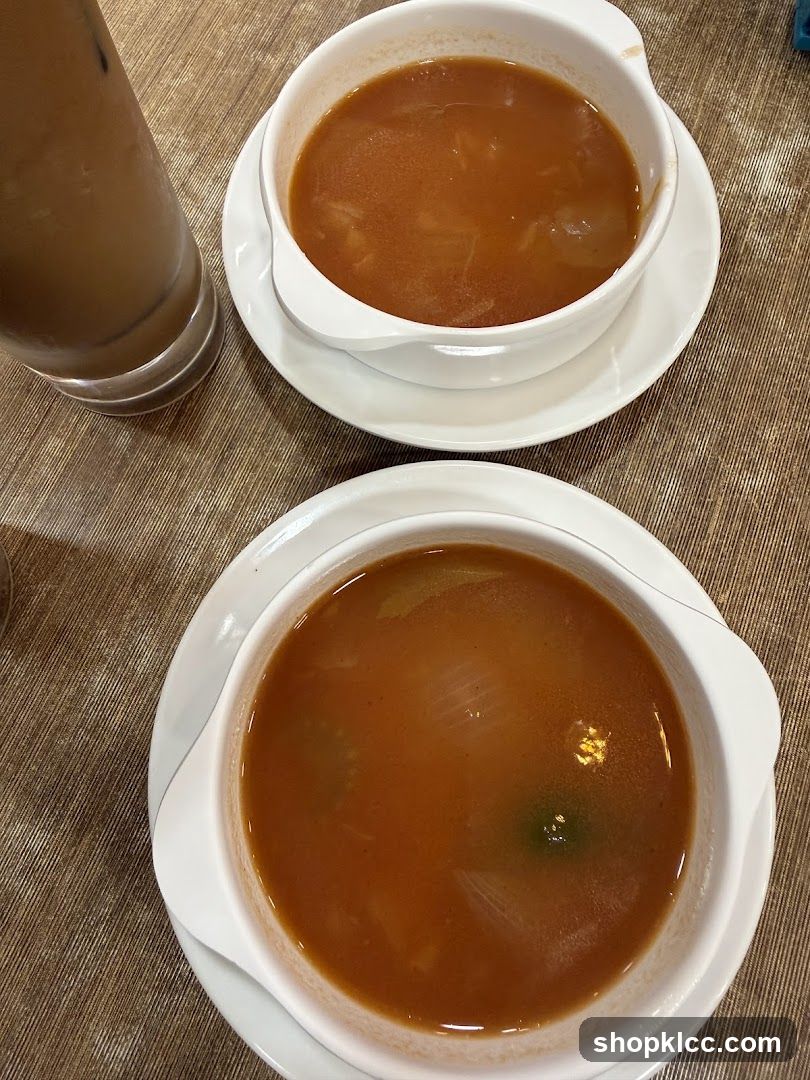 Two bowls of soup and a drink
