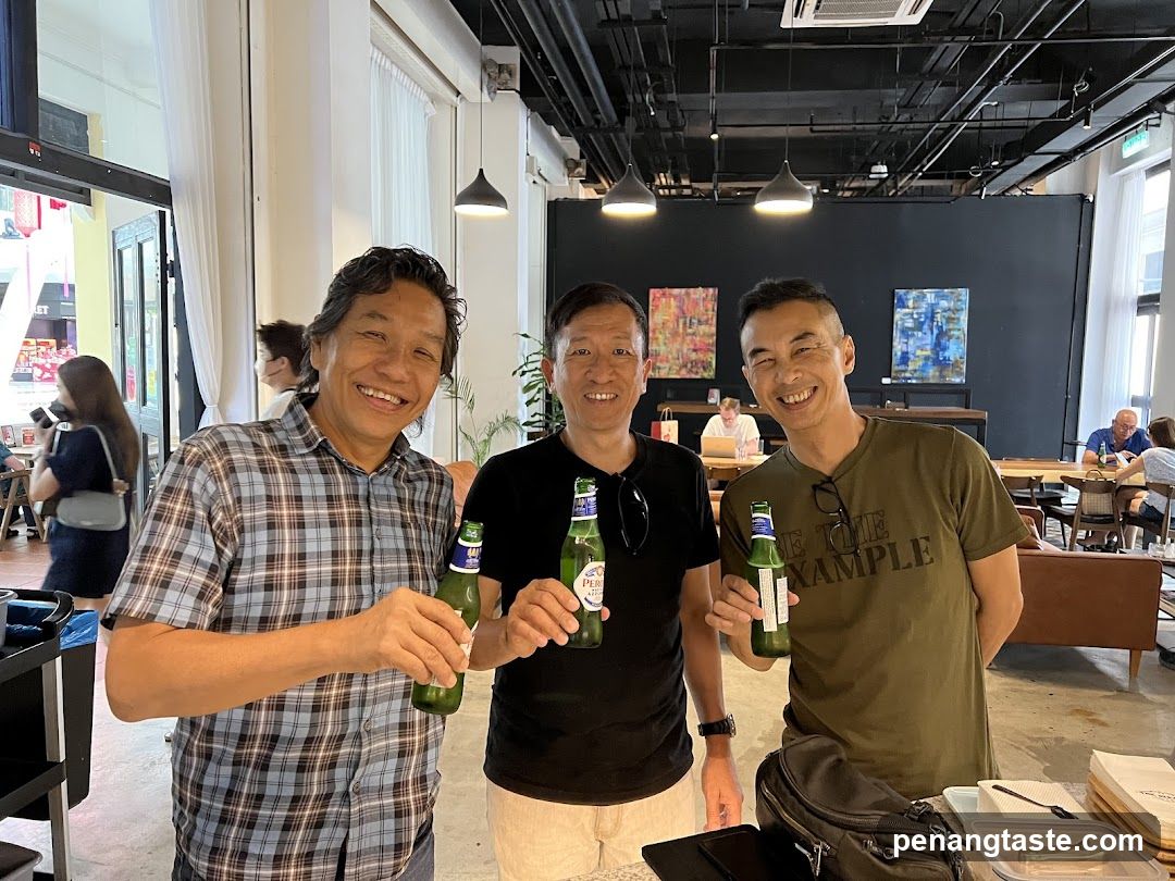 Three men holding beer bottles