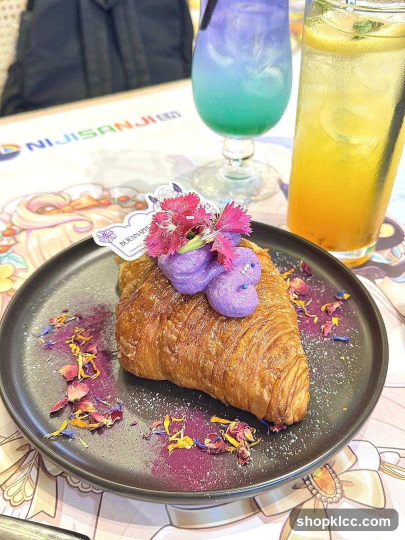 Croissant with purple topping and colorful drinks