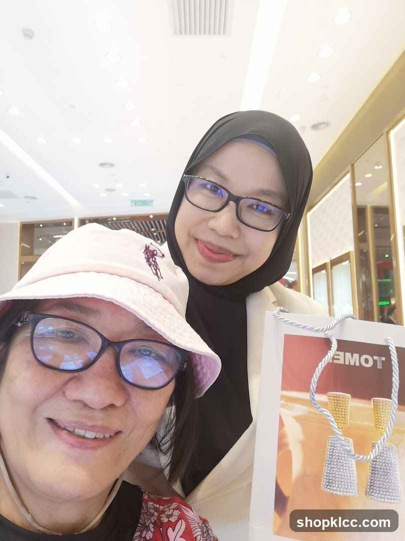Two Women Posing with a Shopping Bag