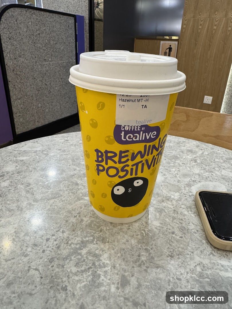 Coffee cup with "Brewing Positivity" slogan