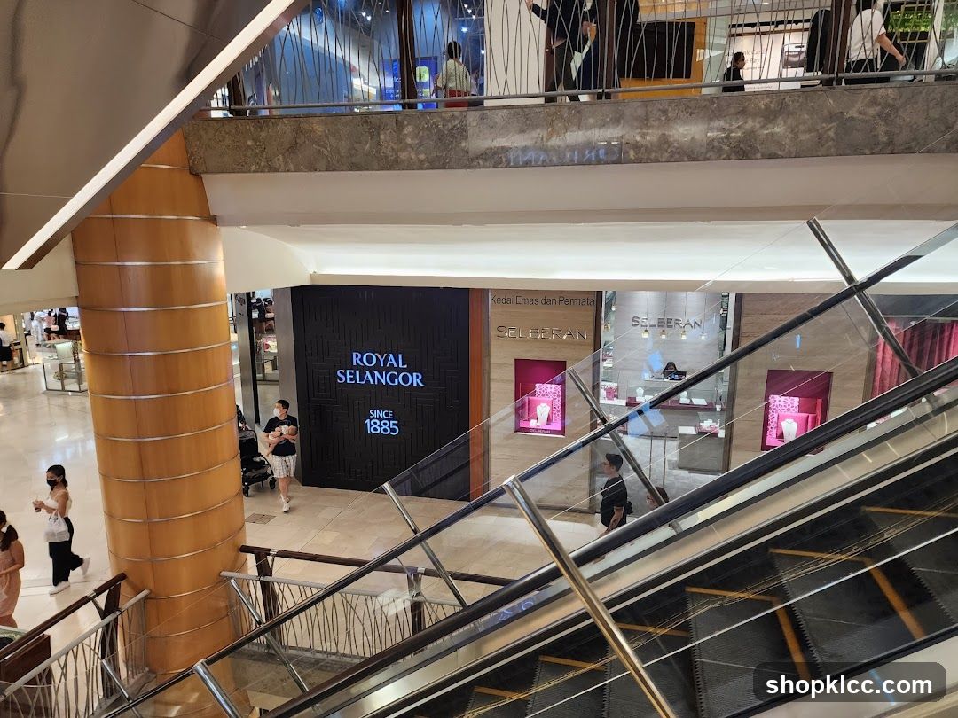 Interior of a shopping mall with escalators and storefronts