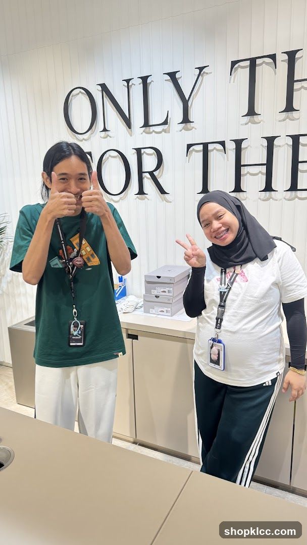 Two people posing in a store