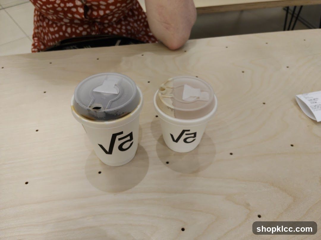 Two coffee cups on a wooden table