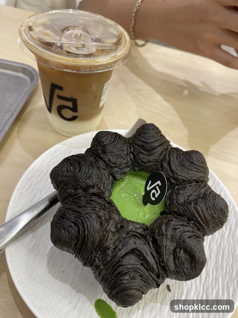 Dark Croissant with Green Filling and Iced Coffee