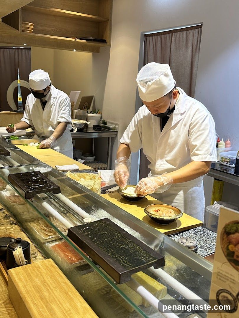 Chefs preparing sushi
