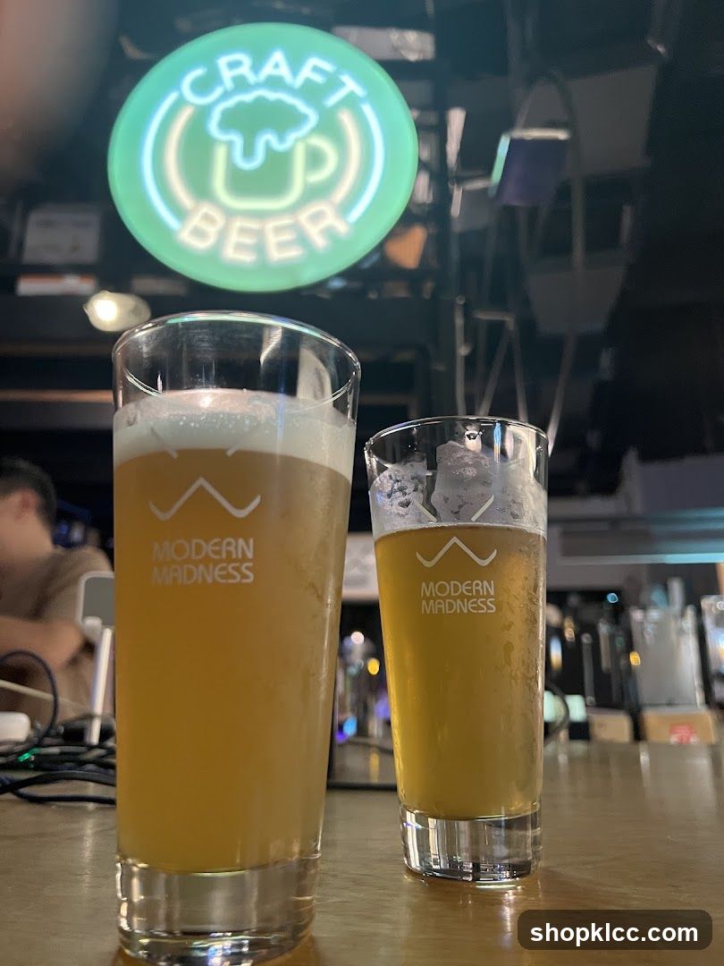 Two glasses of beer on a bar