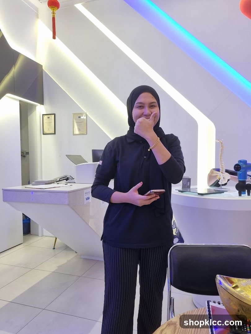 Interior of a modern reception area with staff member posing