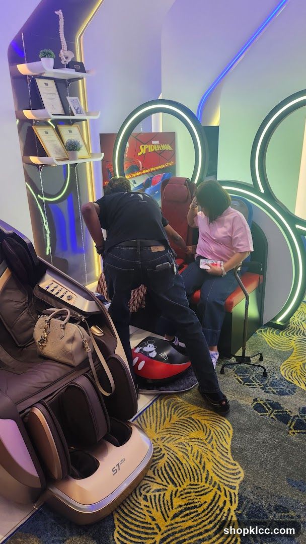 Interior of a modern lounge or spa area with massage chairs and themed decor.