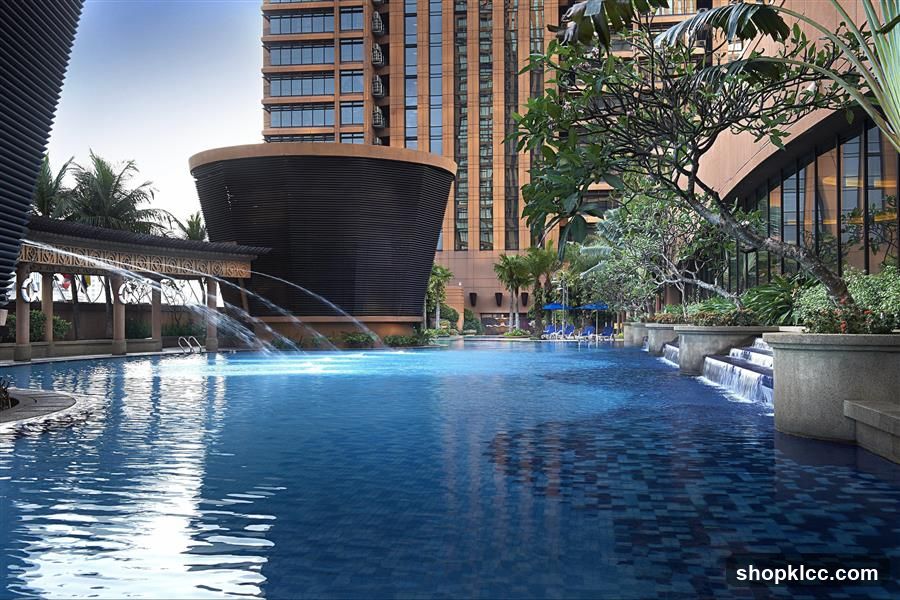 Swimming Pool with Water Features and Hotel Buildings
