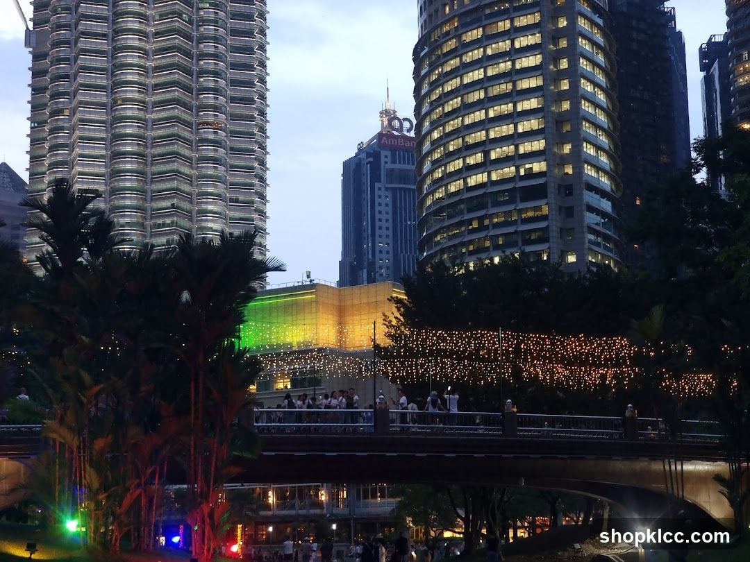 Cityscape at Dusk with Illuminated Buildings and Bridge