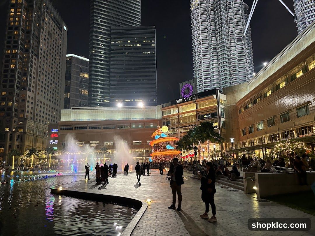 Nighttime view of Suria KLCC with fountains and Petronas Towers