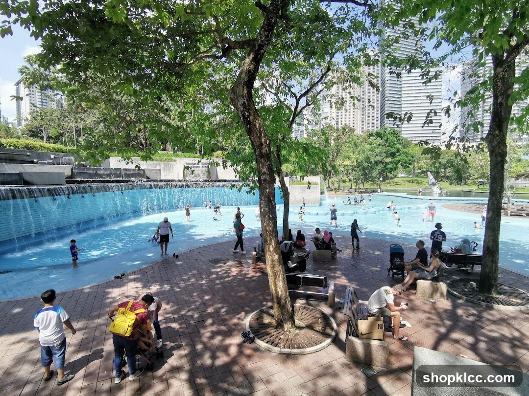 People enjoying a public swimming pool on a sunny day