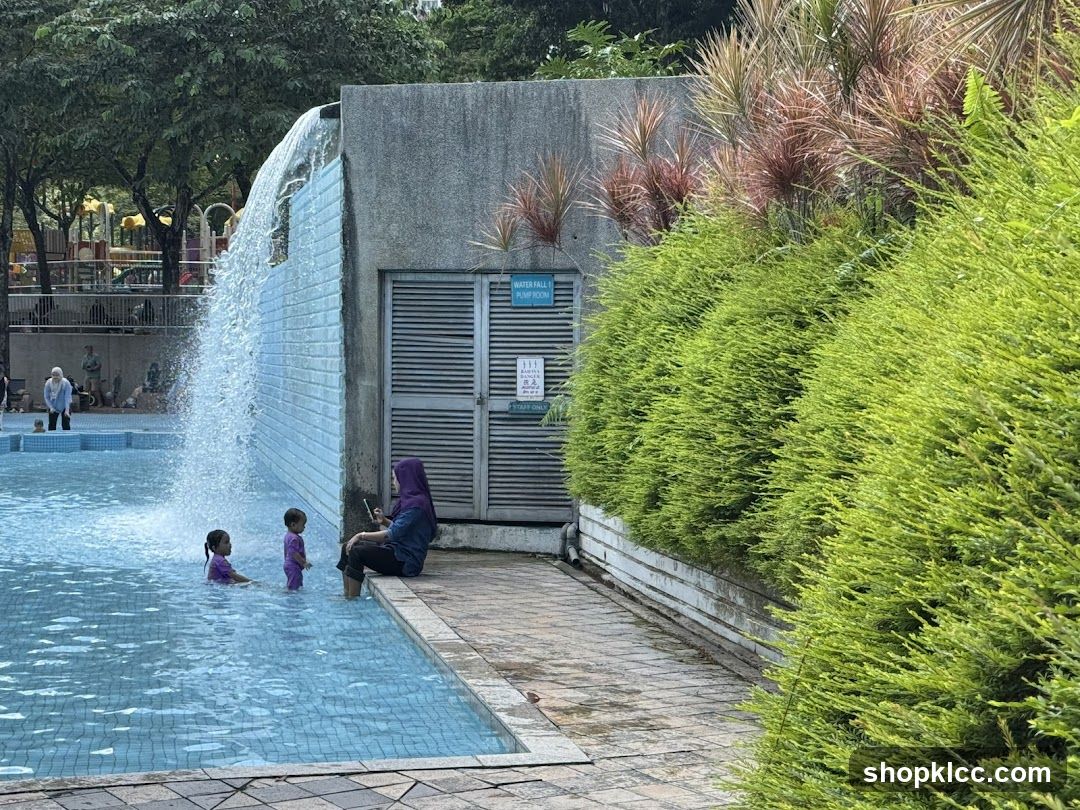 People at a swimming pool with a waterfall