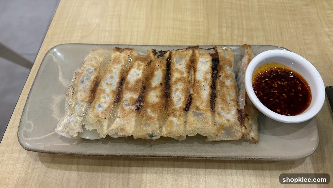 Pan-fried dumplings with dipping sauce