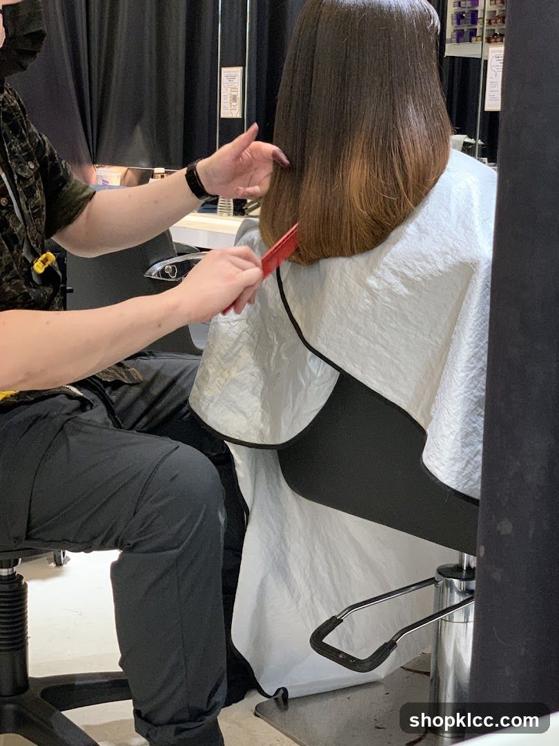 Hairdresser cutting client's hair