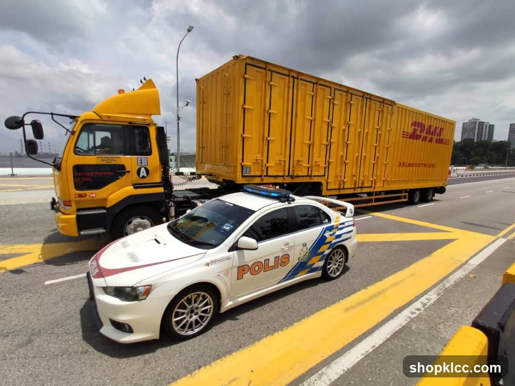 Police Car Escorting DHL Truck