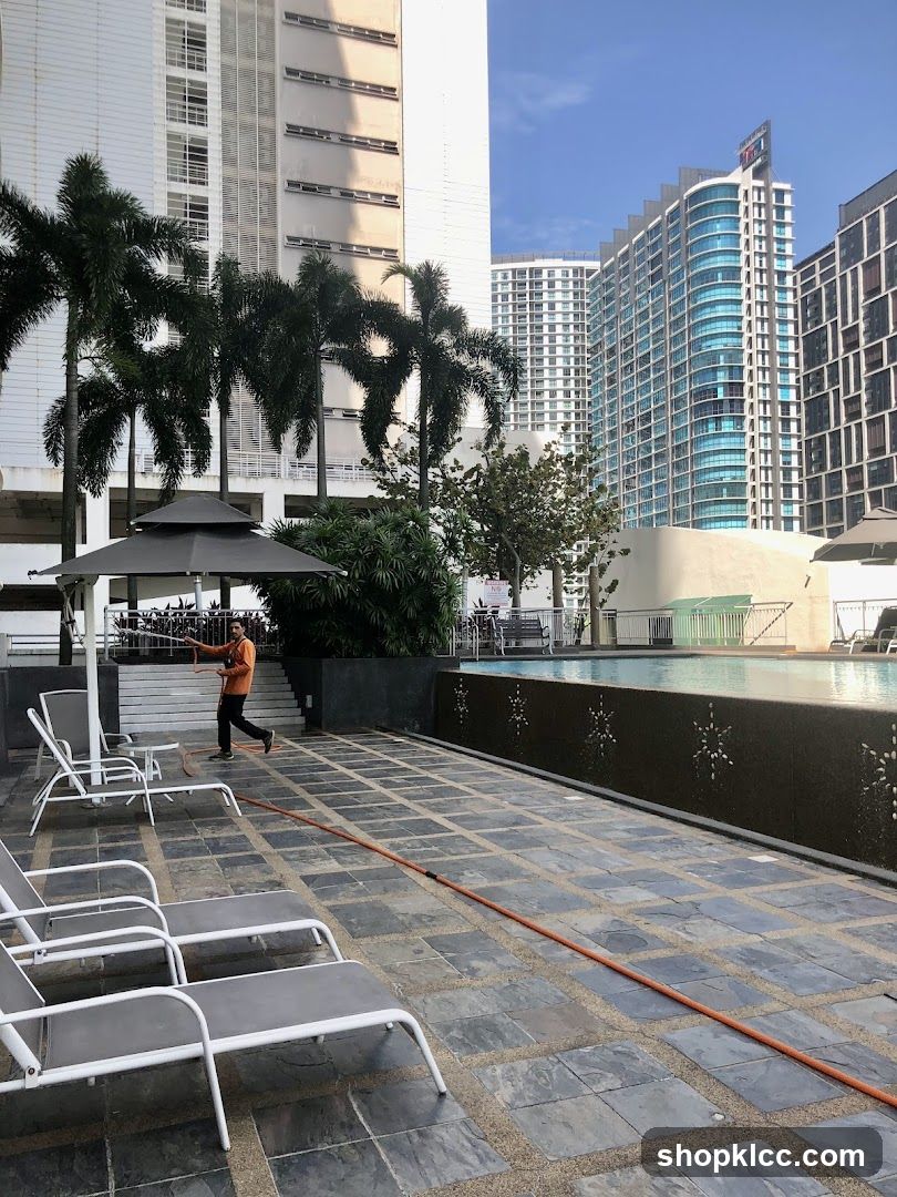 Swimming Pool Area with Lounge Chairs and Buildings