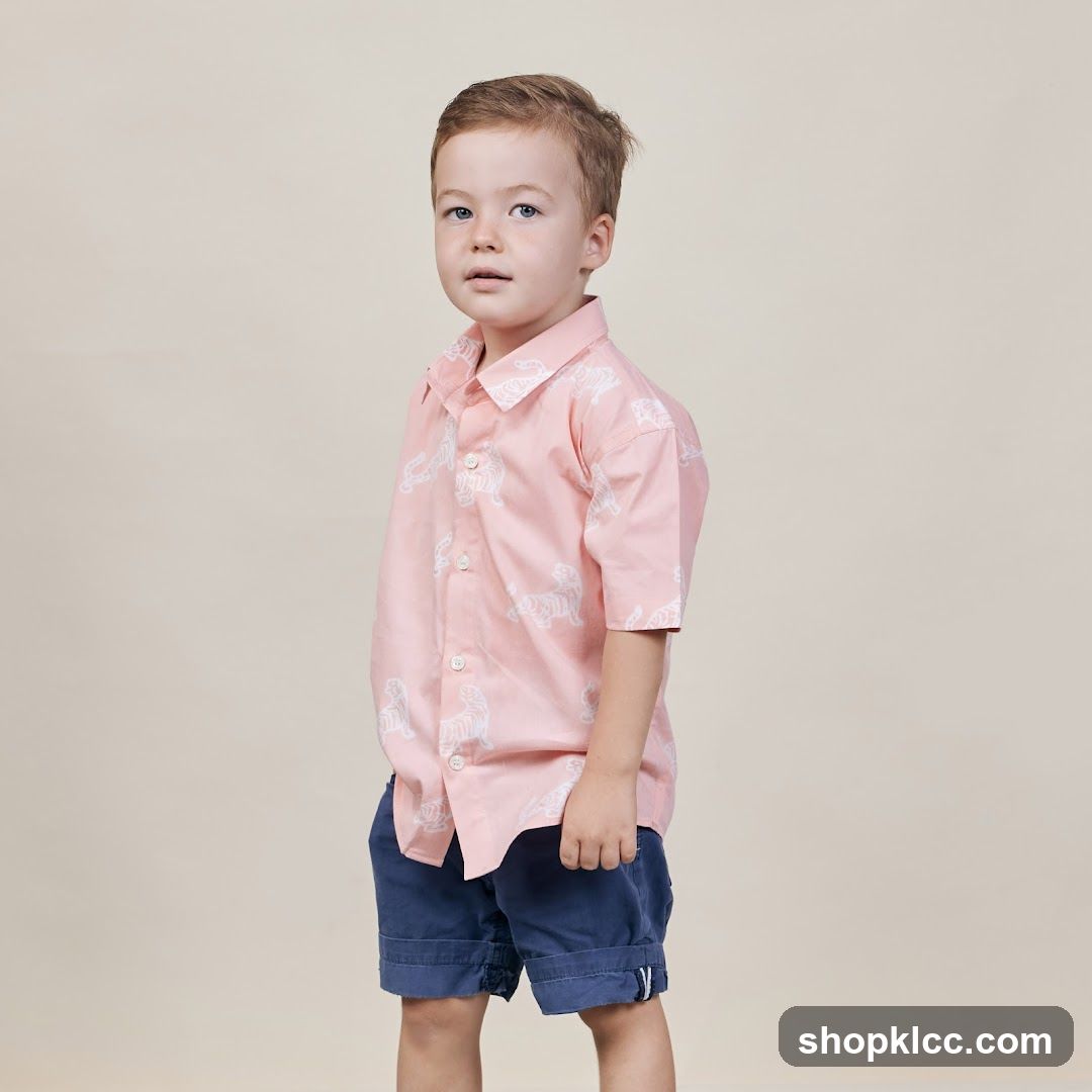 Young Boy in Pink Tiger Print Shirt and Blue Shorts