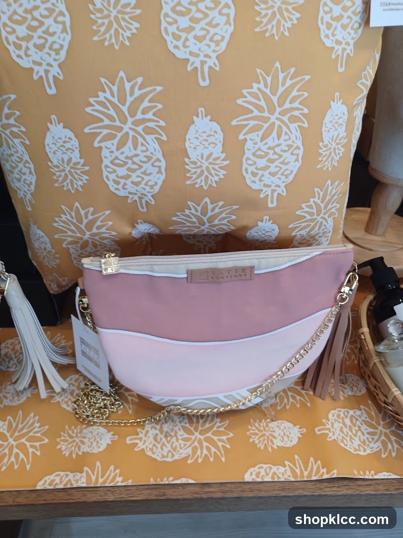 Pink and white handbag with gold chain and tassels