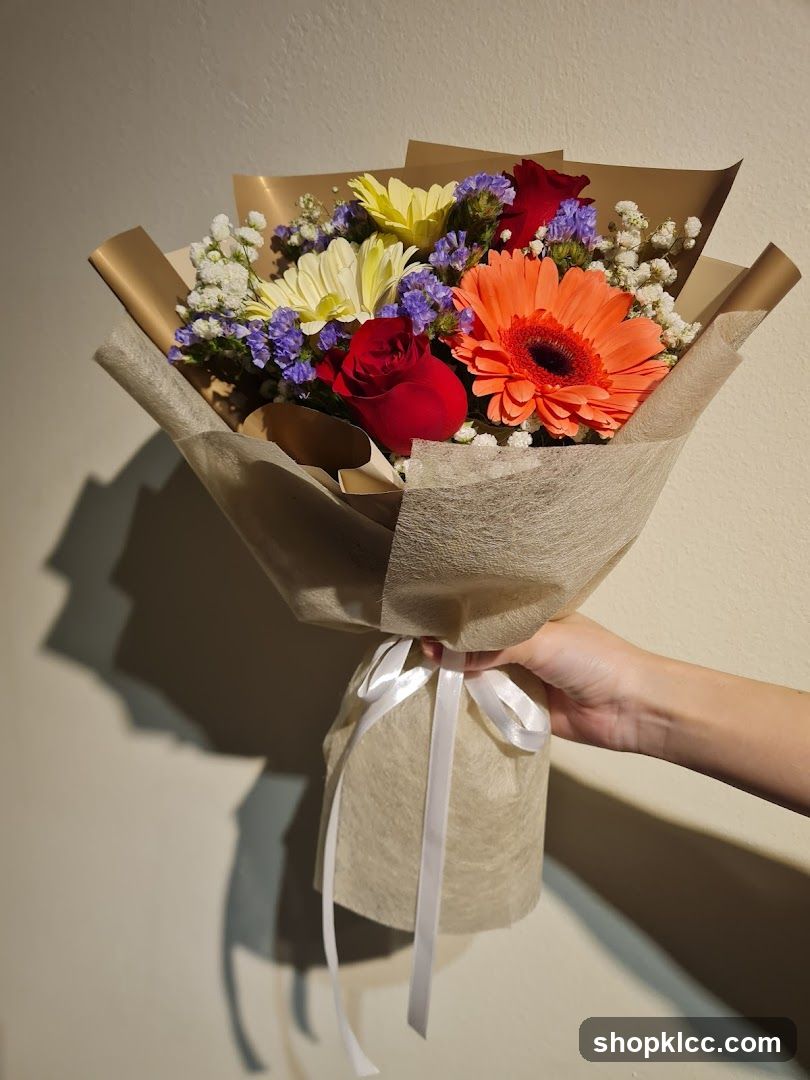 Hand holding a bouquet of flowers