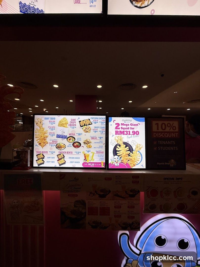 Digital menu display showing fried squid and chicken products with prices in RM, promotional offers like '2 Squids for RM31.90', and a 10% discount sign.