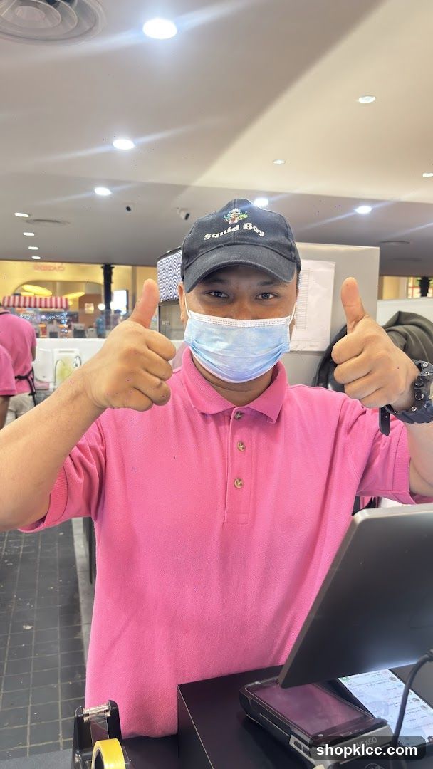 Staff giving thumbs up at counter